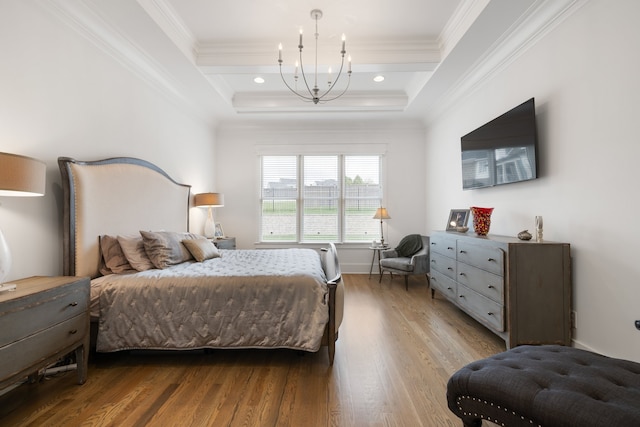 bedroom featuring light hardwood / wood-style flooring, a raised ceiling, a chandelier, and crown molding