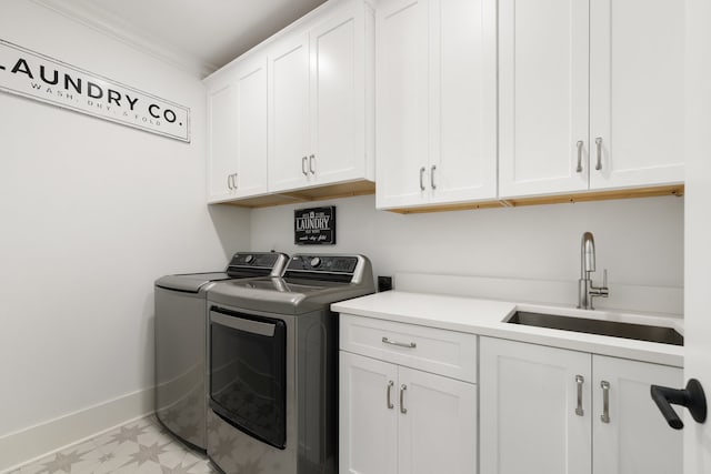 laundry room featuring sink, cabinets, independent washer and dryer, and ornamental molding