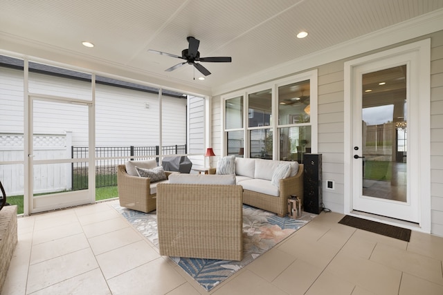 sunroom featuring ceiling fan