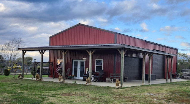 exterior space with a garage and a lawn