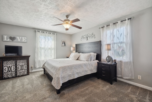 carpeted bedroom featuring ceiling fan and a textured ceiling