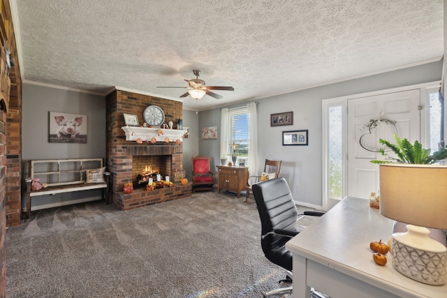 carpeted home office with a brick fireplace, ceiling fan, a textured ceiling, and ornamental molding