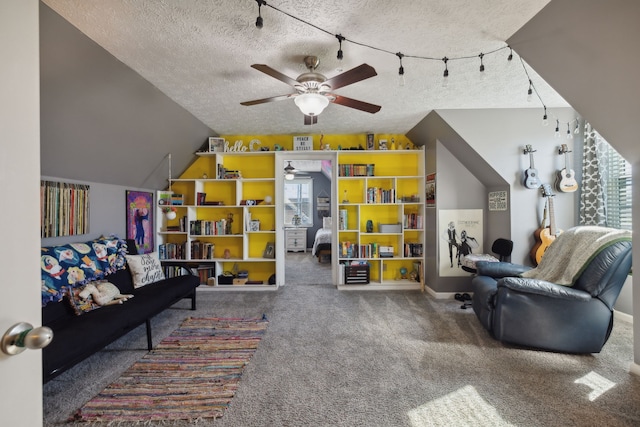 carpeted living room with a healthy amount of sunlight, lofted ceiling, a textured ceiling, and ceiling fan