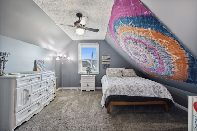 carpeted bedroom with lofted ceiling, a textured ceiling, and ceiling fan