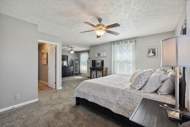 bedroom with a textured ceiling, light colored carpet, and ceiling fan