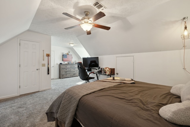 bedroom featuring ceiling fan, a textured ceiling, carpet flooring, and lofted ceiling