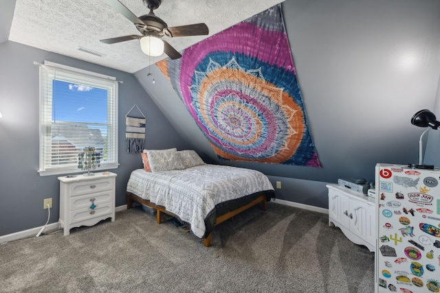 carpeted bedroom featuring lofted ceiling, a textured ceiling, and ceiling fan