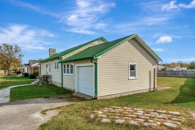 view of property exterior with a garage and a lawn