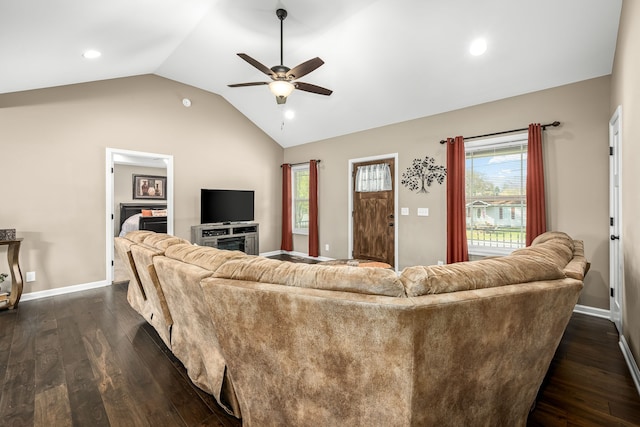 living room with dark wood-type flooring, ceiling fan, and vaulted ceiling