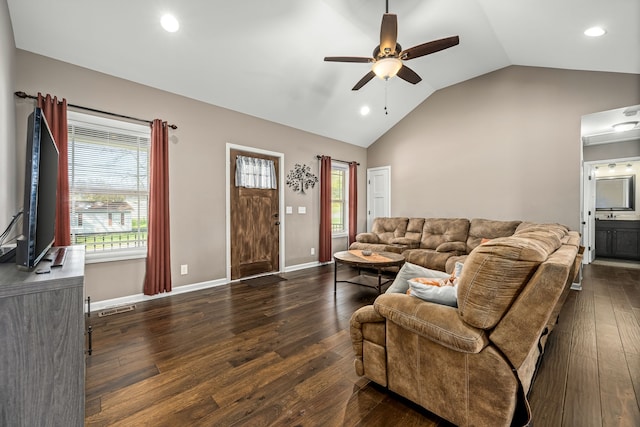 living room with dark wood-type flooring, ceiling fan, and lofted ceiling