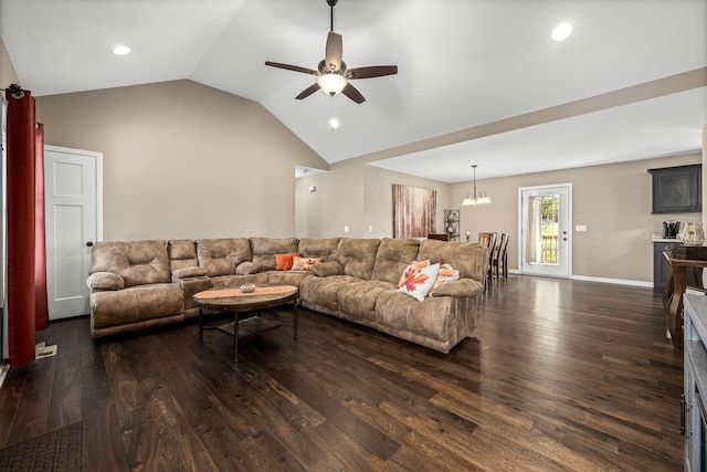 living room featuring dark wood-type flooring, vaulted ceiling, and ceiling fan with notable chandelier