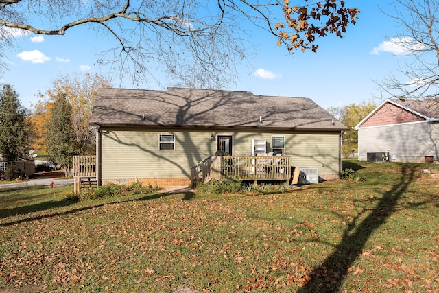 rear view of property featuring a yard and a deck