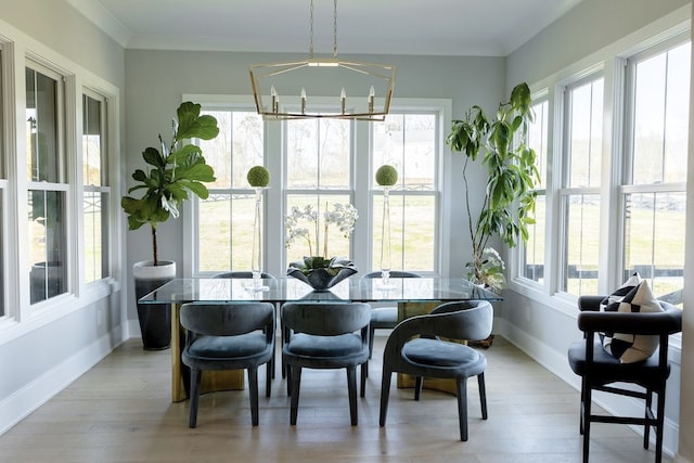 sunroom featuring a healthy amount of sunlight and an inviting chandelier