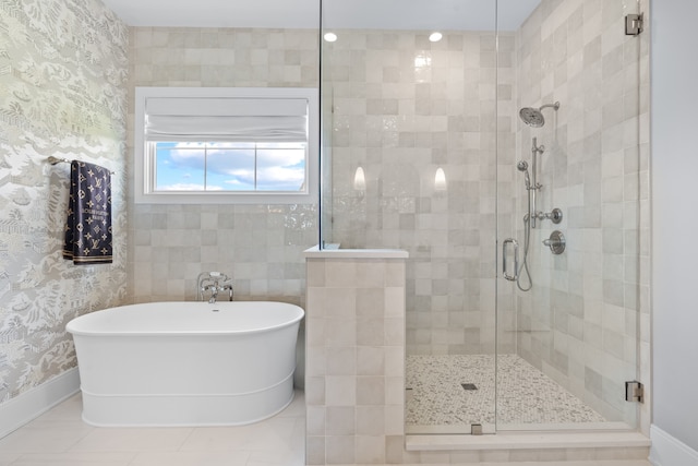 full bathroom featuring a shower stall, tile patterned floors, a freestanding tub, and wallpapered walls