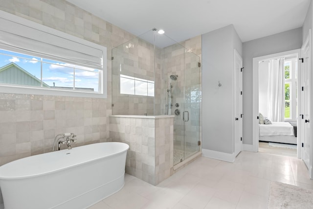 5124 Bond Mill Rd, Thompsons Station, TN 37179 - bathroom featuring a soaking tub, a shower stall, ensuite bath, tile patterned flooring, and baseboards