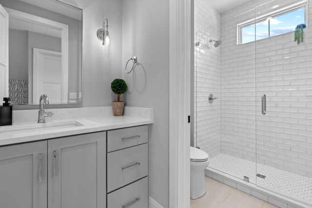 full bathroom featuring a stall shower, tile patterned flooring, vanity, and toilet