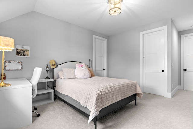 bedroom featuring lofted ceiling, baseboards, and light colored carpet