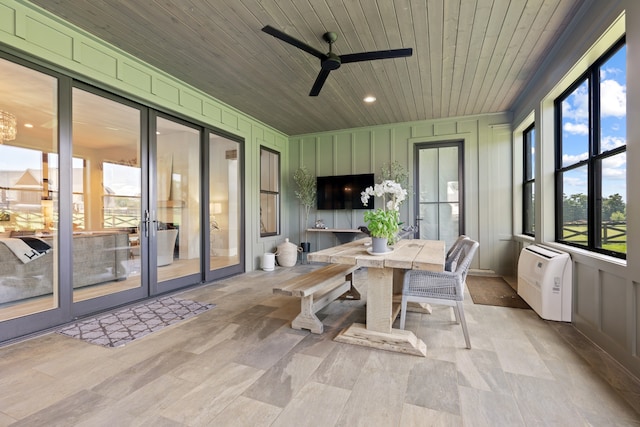 sunroom / solarium featuring a ceiling fan and wood ceiling