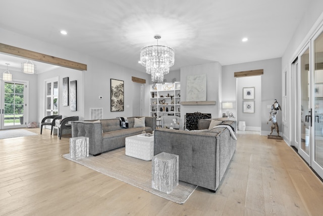 living room with light wood-style floors, a fireplace, visible vents, and recessed lighting