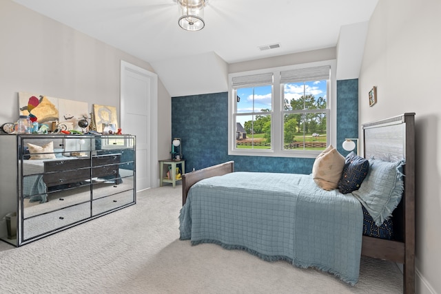 bedroom featuring visible vents, vaulted ceiling, and carpet flooring