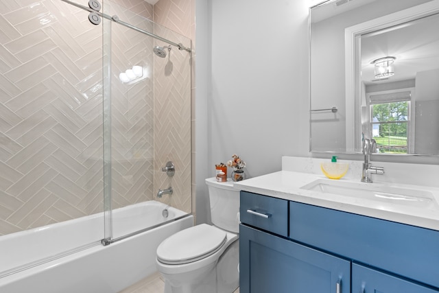 bathroom featuring combined bath / shower with glass door, vanity, and toilet