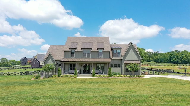 view of front facade featuring a porch, metal roof, a standing seam roof, fence, and a front lawn