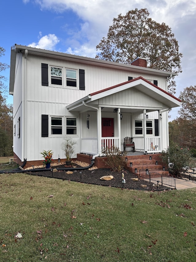 view of front of home featuring a front lawn and covered porch