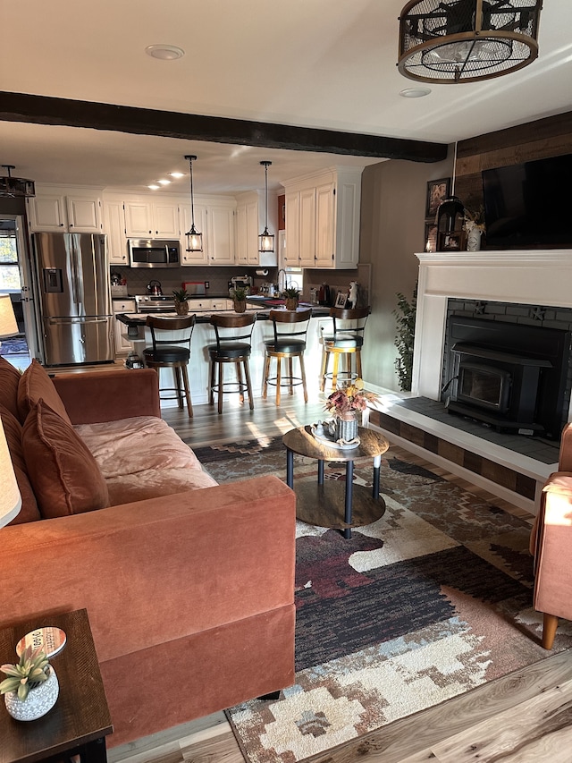 living room featuring wood-type flooring and beam ceiling