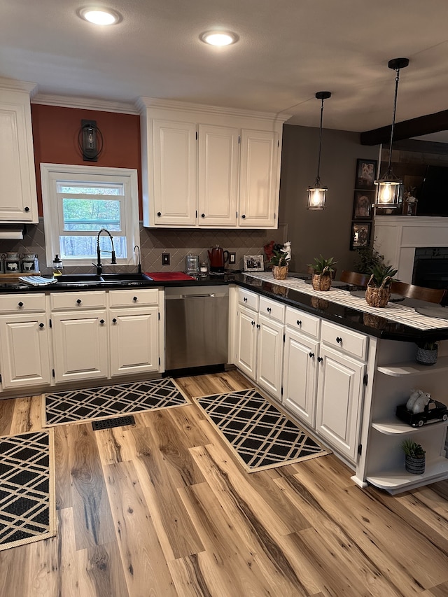 kitchen with white cabinets, sink, and dishwasher