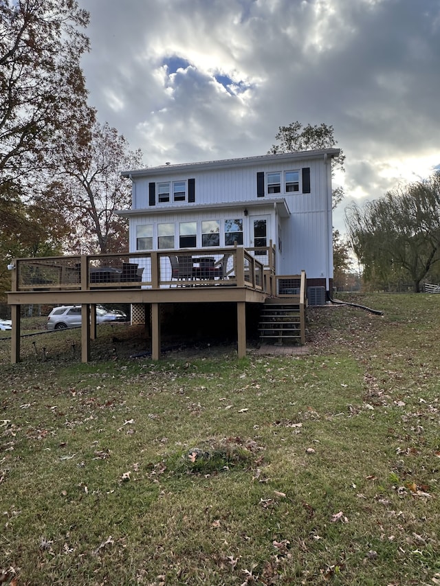 rear view of property with a lawn and a deck