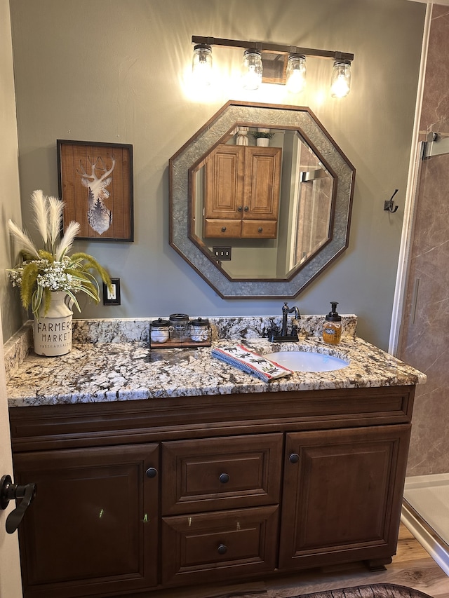 bathroom featuring vanity and hardwood / wood-style flooring