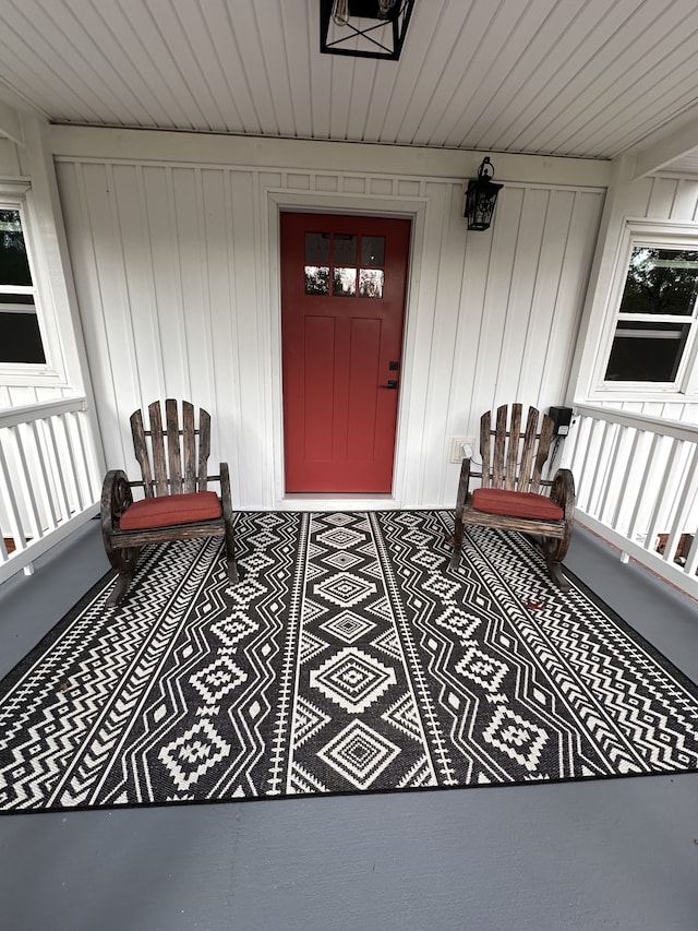 view of exterior entry with a porch