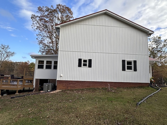 view of side of home featuring central air condition unit, a yard, and a deck