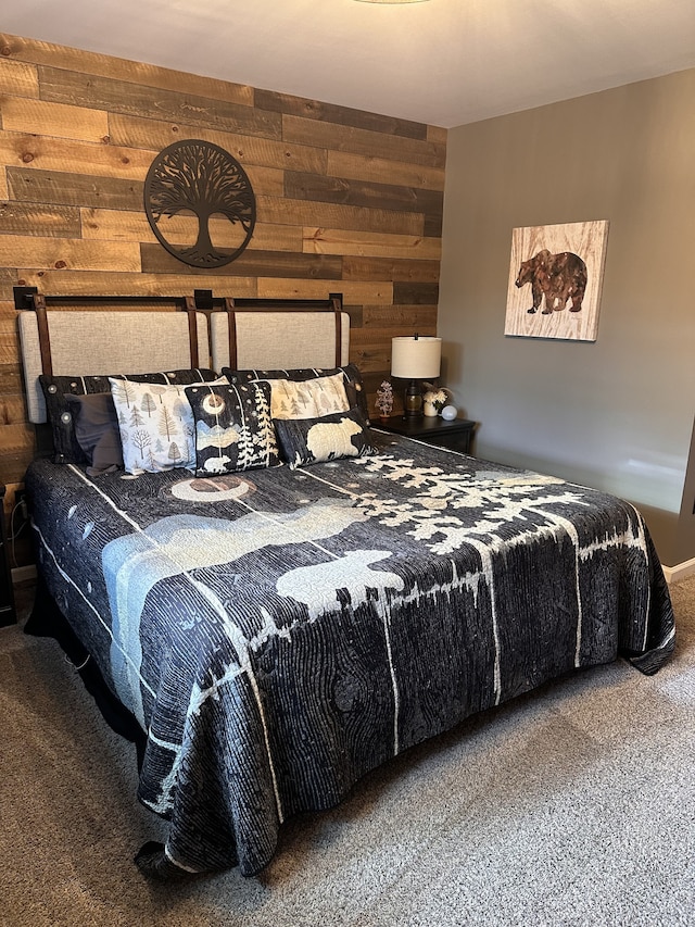 bedroom featuring wood walls and carpet