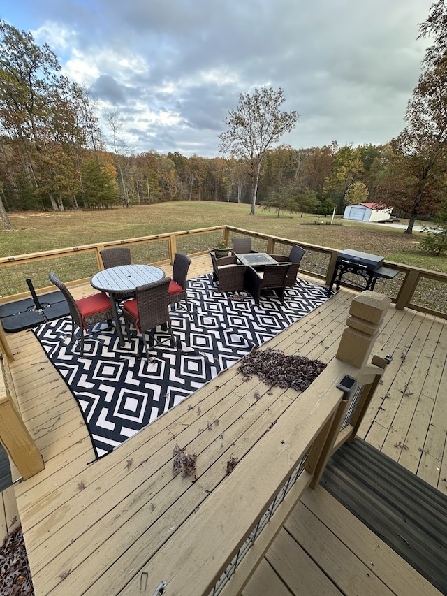 wooden deck featuring a lawn