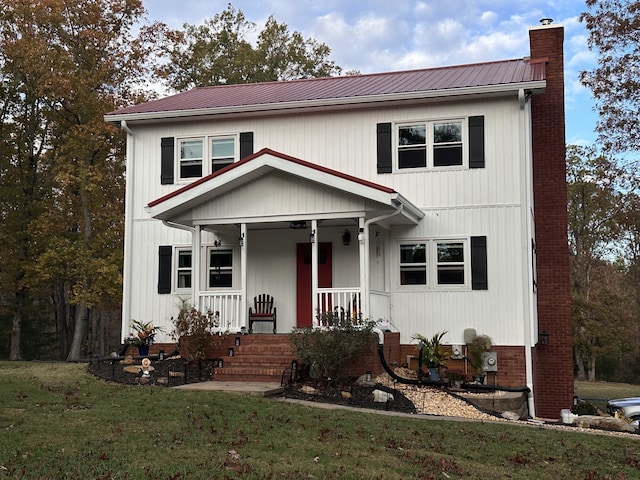 view of front facade with a front lawn and covered porch