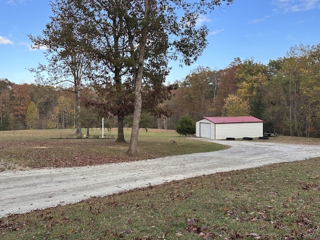 view of yard with a garage and an outdoor structure