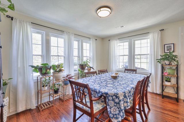 dining space featuring dark hardwood / wood-style floors