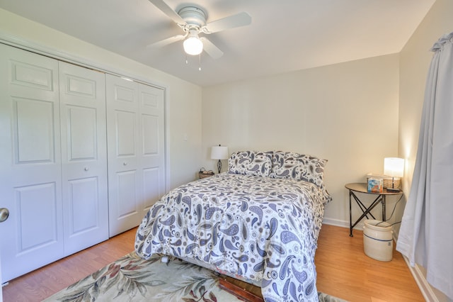 bedroom featuring hardwood / wood-style flooring, ceiling fan, and a closet