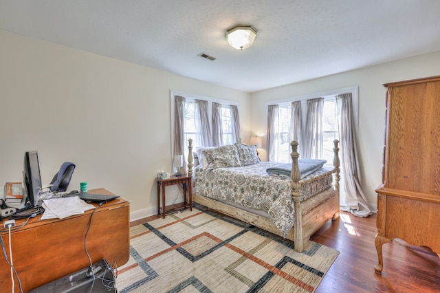 bedroom with hardwood / wood-style flooring