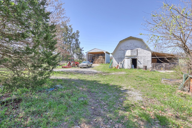 view of yard with a storage shed and a carport