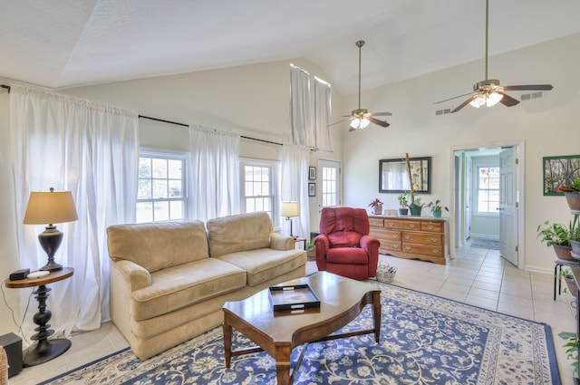 tiled living room featuring high vaulted ceiling, plenty of natural light, and ceiling fan