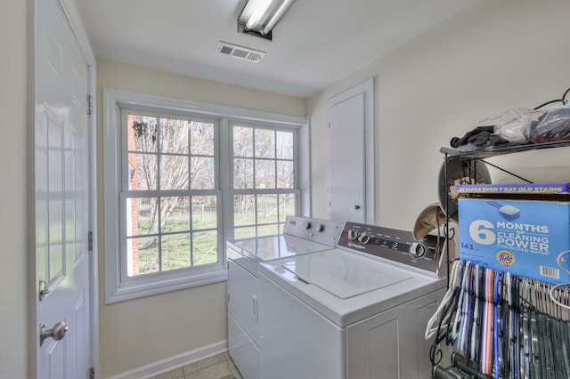 laundry room with separate washer and dryer and light tile patterned floors