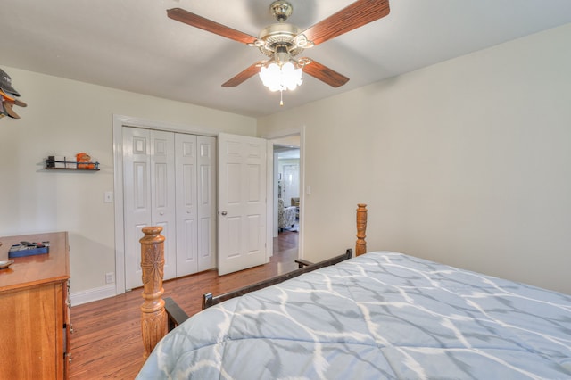 bedroom featuring light hardwood / wood-style floors, ceiling fan, and a closet