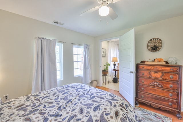 bedroom with ceiling fan and light wood-type flooring