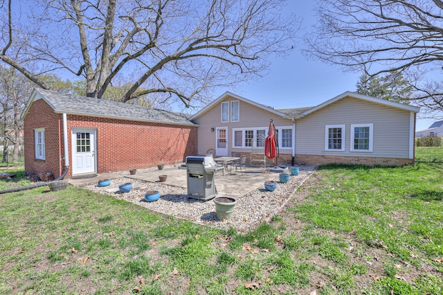 rear view of property featuring a patio and a lawn