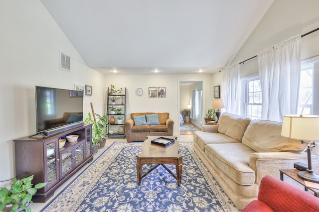 living room featuring high vaulted ceiling