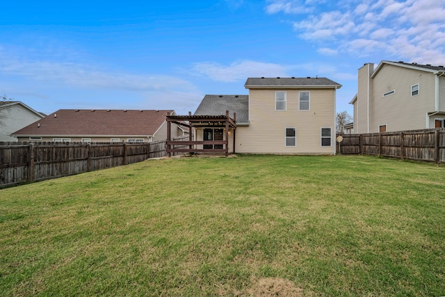 back of property with a pergola and a yard