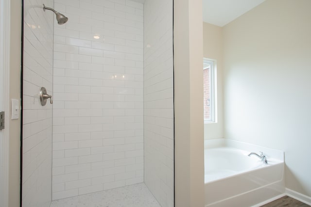 bathroom featuring plus walk in shower