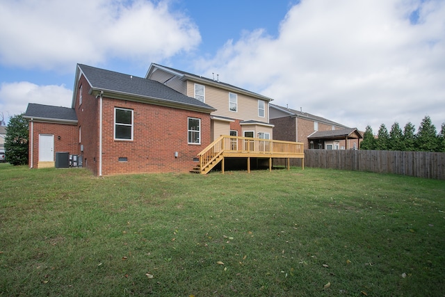 rear view of property featuring a wooden deck, a lawn, and central AC